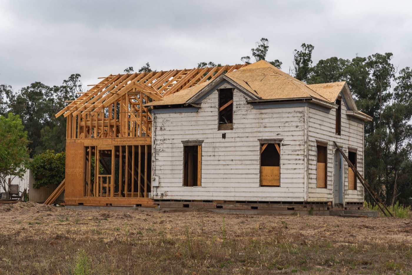 Older house with a new timber-framed addition under construction