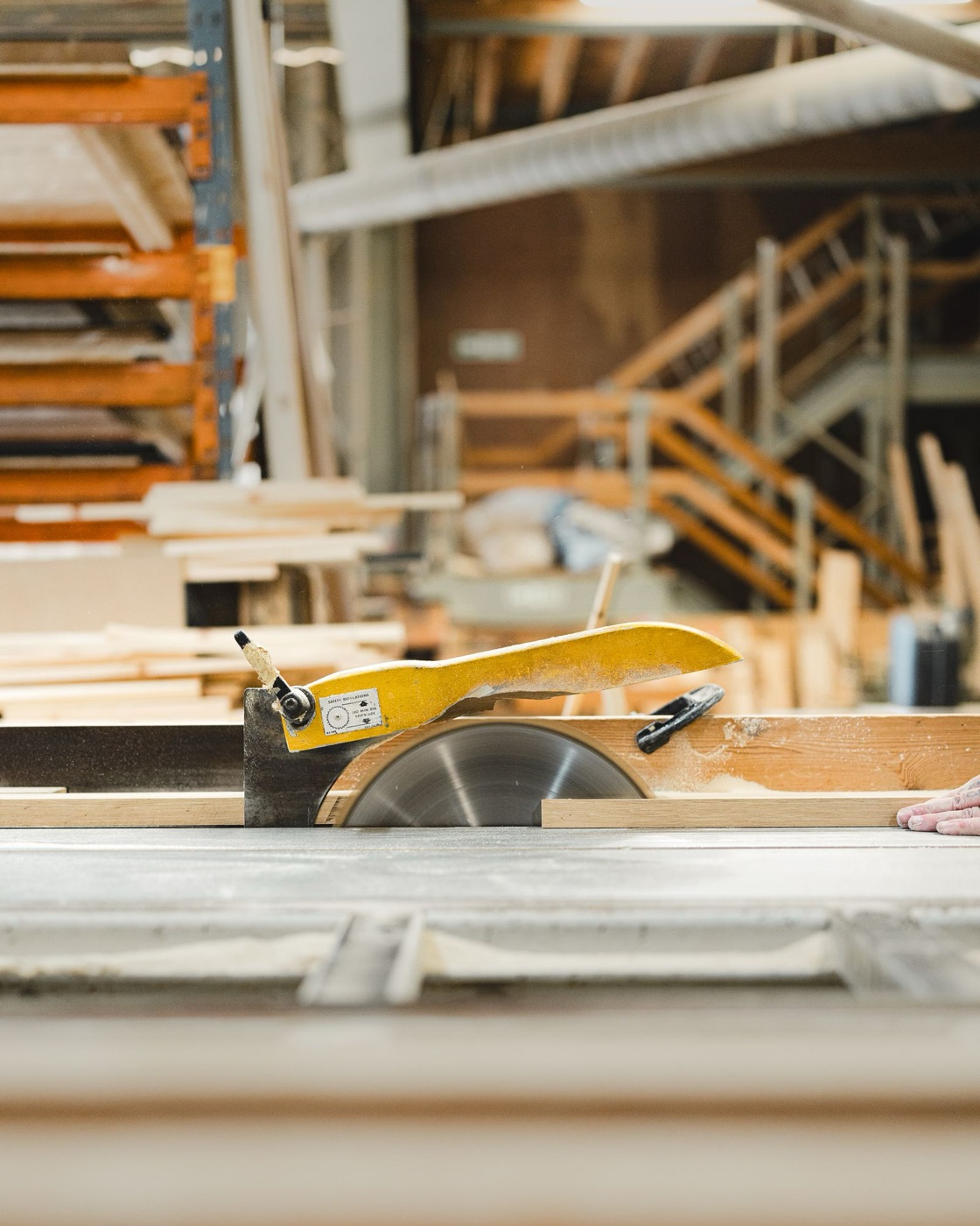 Carpentry shop with a circular saw and stacked lumber